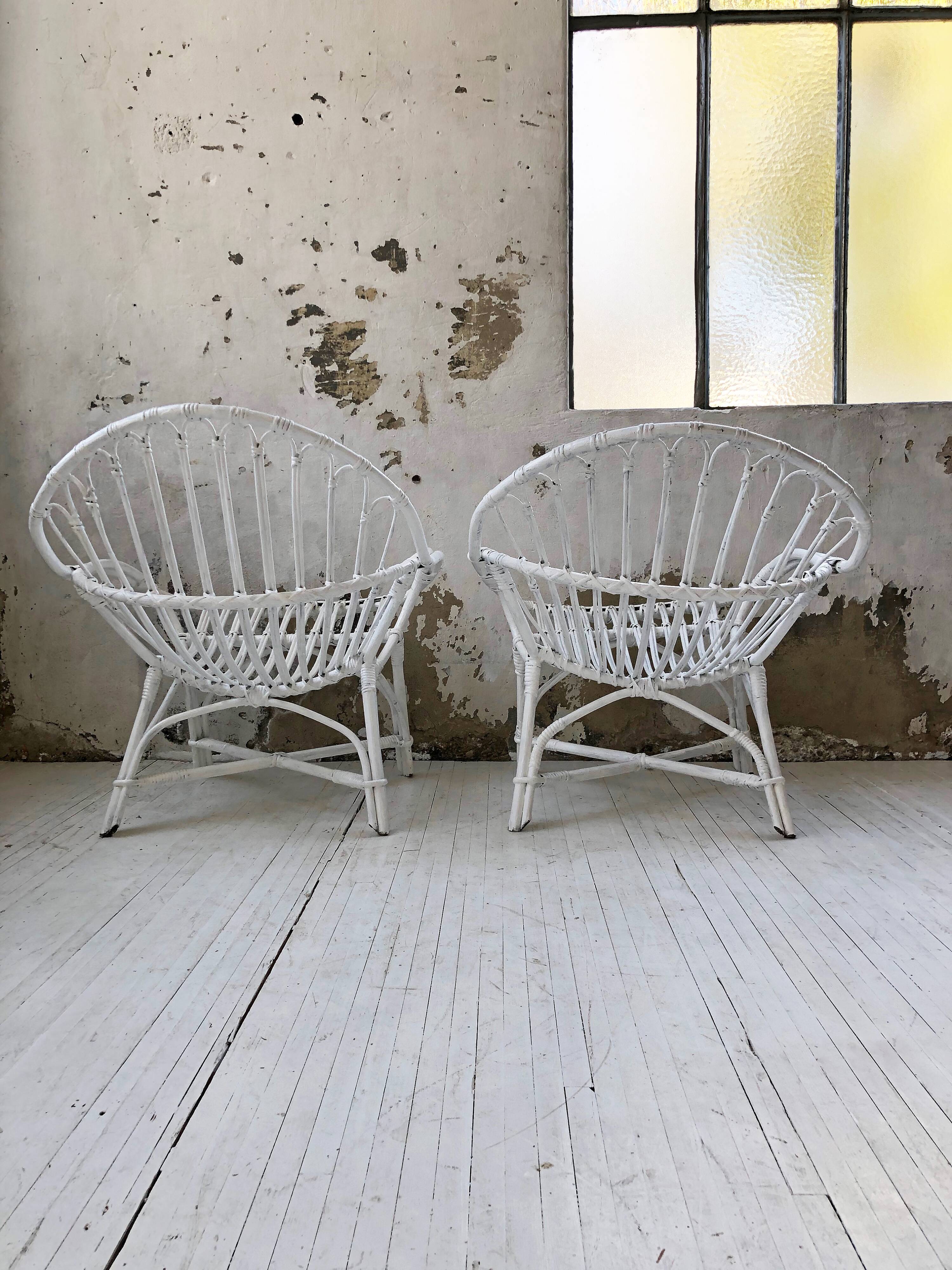 Pair of white rotin armchairs