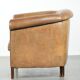 Vintage sheepskin club armchair finished with decorative nails