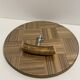 Vintage round wooden cheese board covered with glass plate with foldable handle