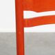 Vintage 1970s red wooden chair with a woven wicker seat