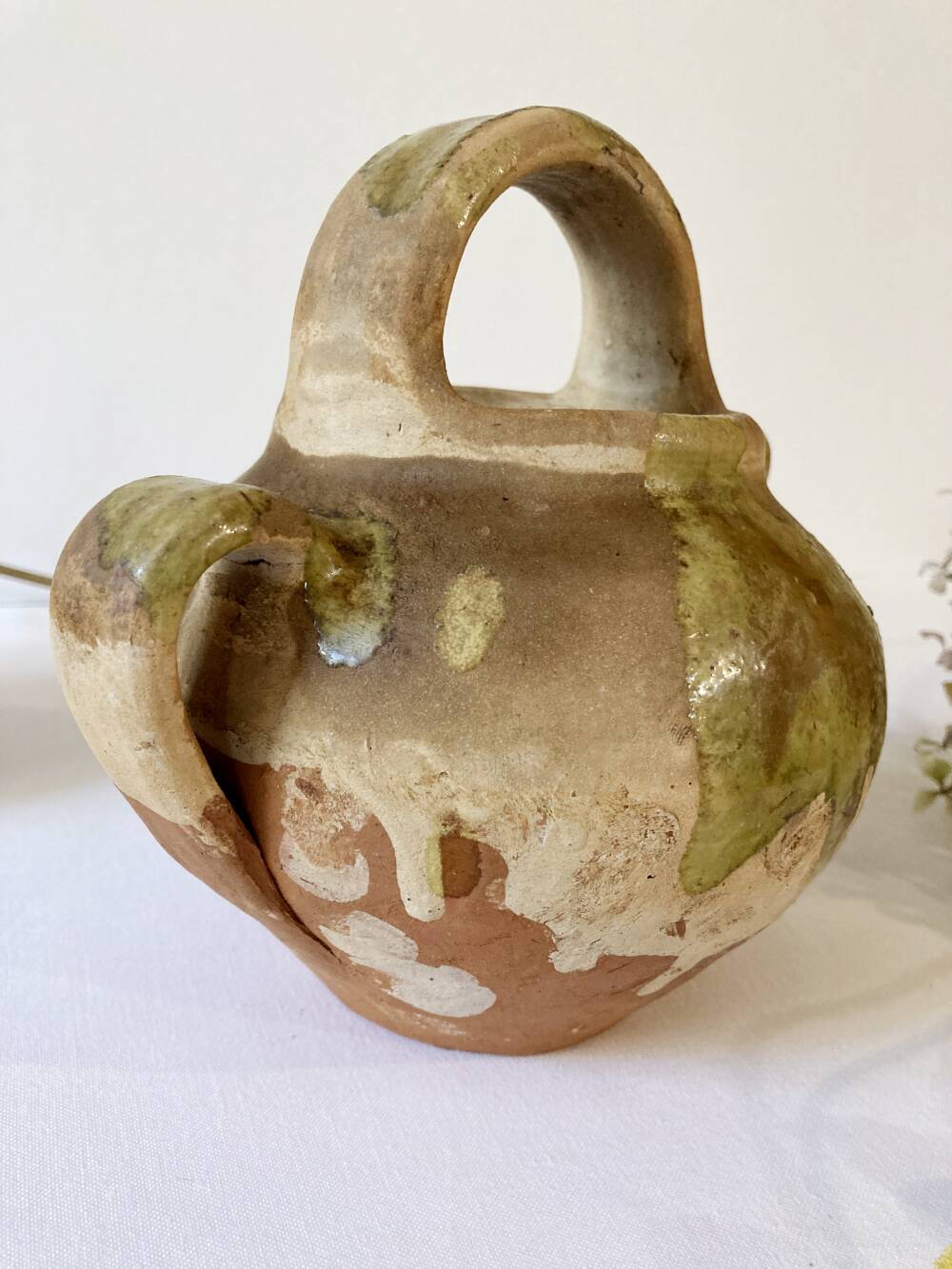 Small Provençal goat jug in creamy white and green enamelled stoneware