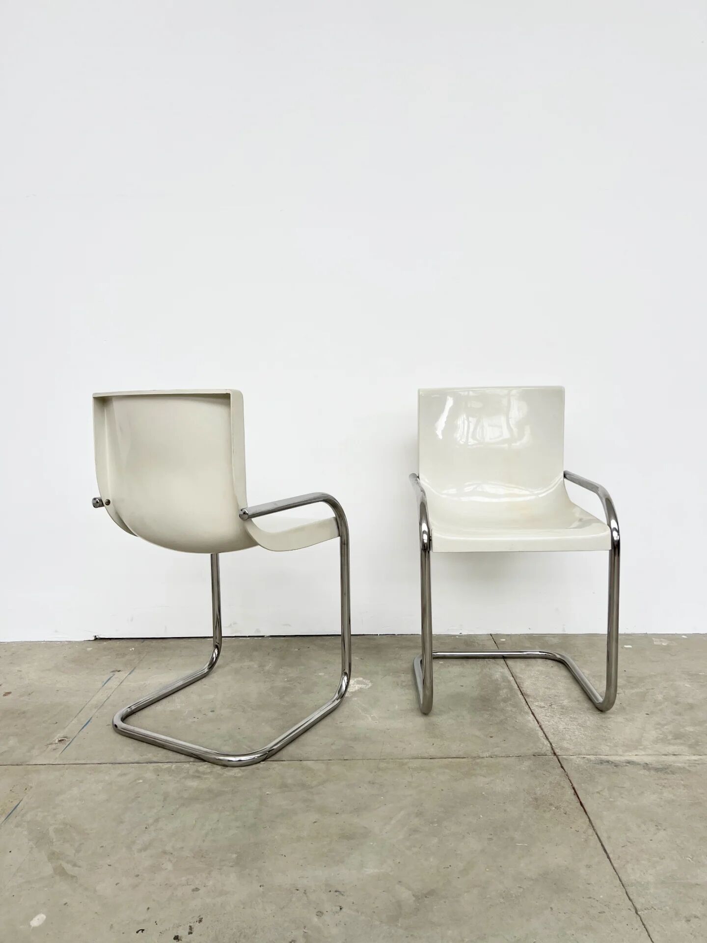 Pair of white moulded shell chairs with chrome tube — Space Age 70s