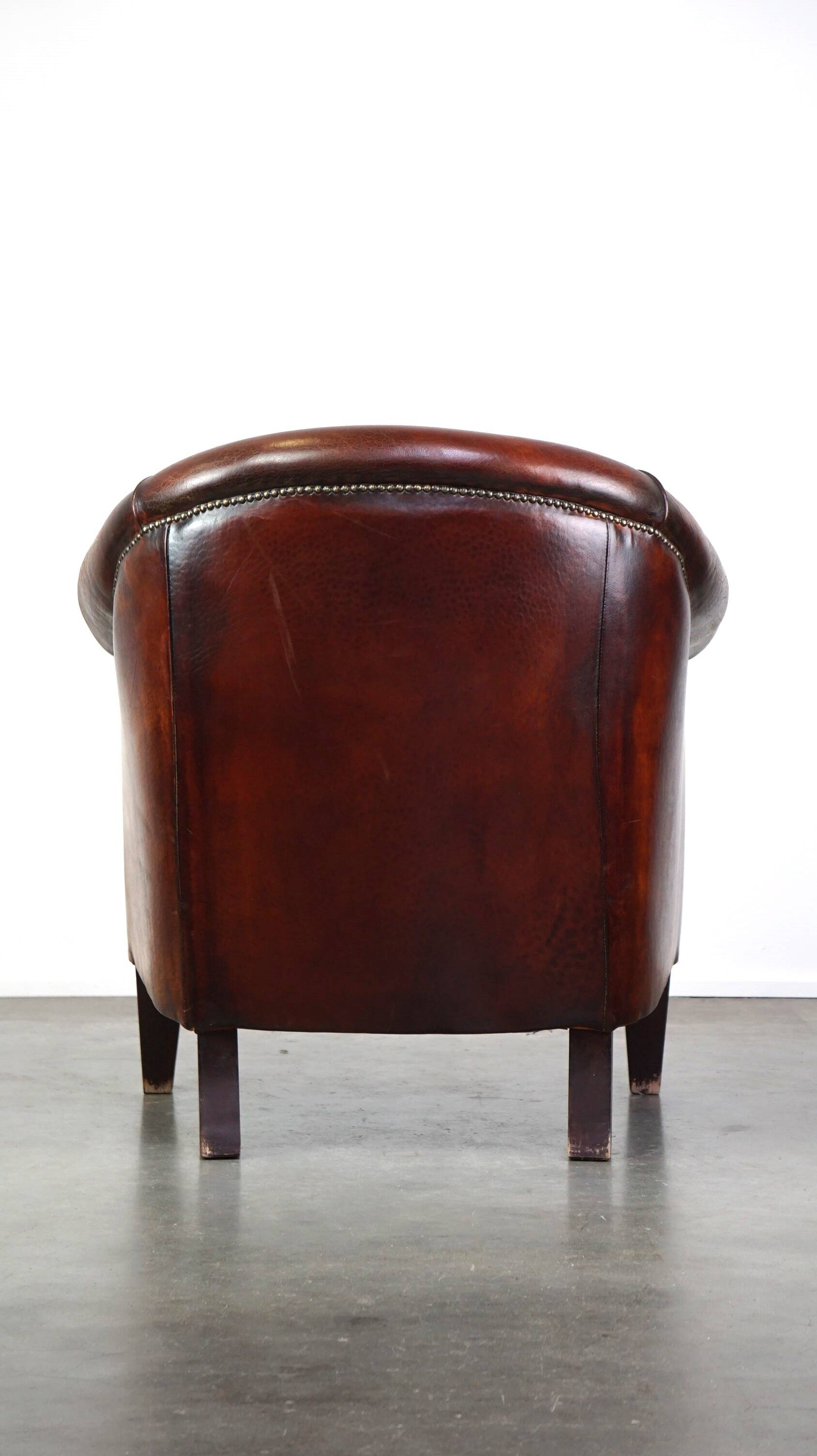 Very luxurious dark brown sheepskin club chair with a more than beautiful patina