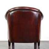 Very luxurious dark brown sheepskin club chair with a more than beautiful patina