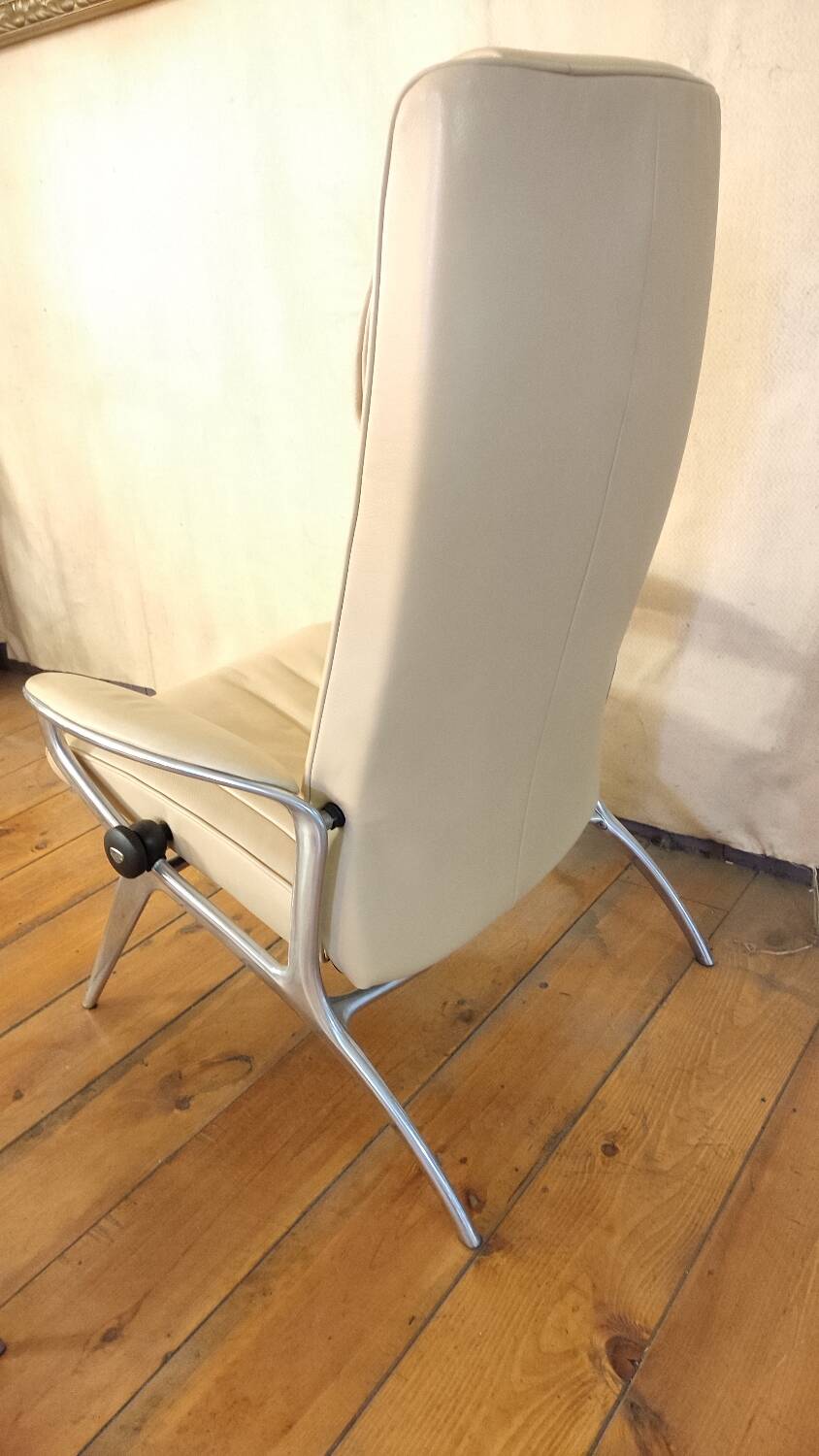 Beige leather armchair and footstool