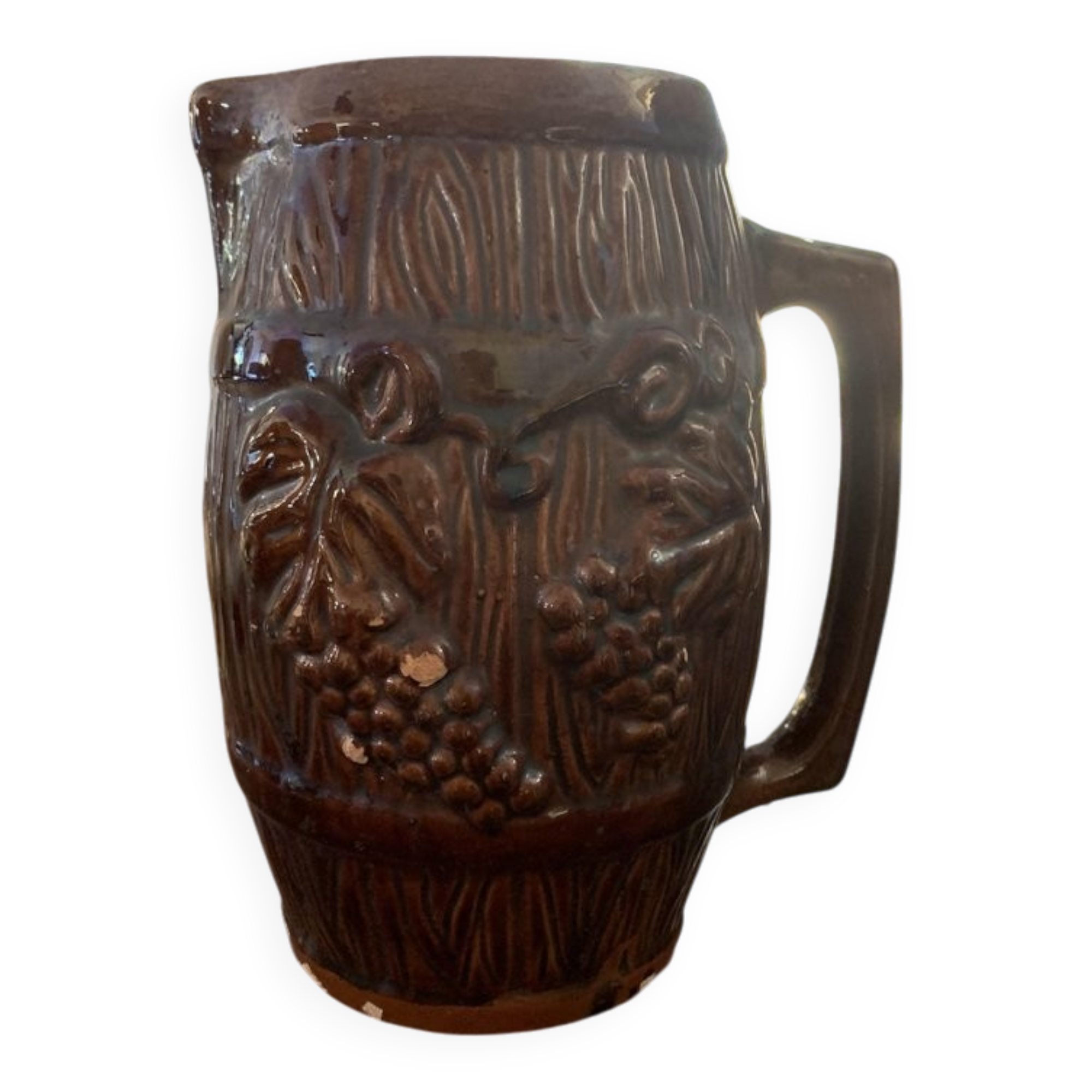 Hungarian folk ceramic pitcher with a brown glossy finish and relief decoration of vine.