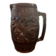 Hungarian folk ceramic pitcher with a brown glossy finish and relief decoration of vine.