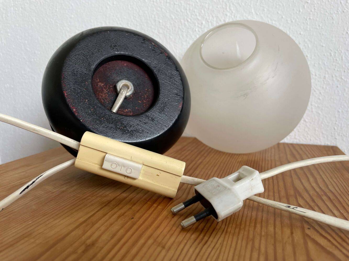 Small black wooden table lamp with frosted glass globe