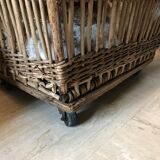 Rattan laundry basket on vintage wheels