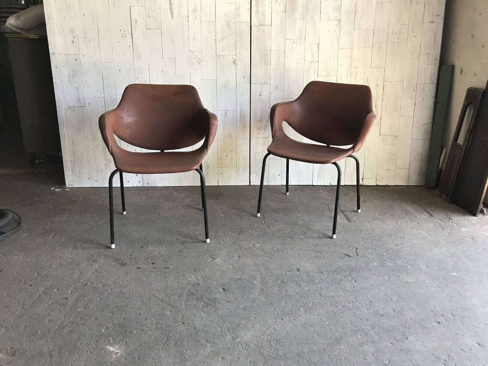 Set of 2 mid-century brown faux leather armchairs with black metal legs, 1960s.