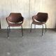 Set of 2 mid-century brown faux leather armchairs with black metal legs, 1960s.