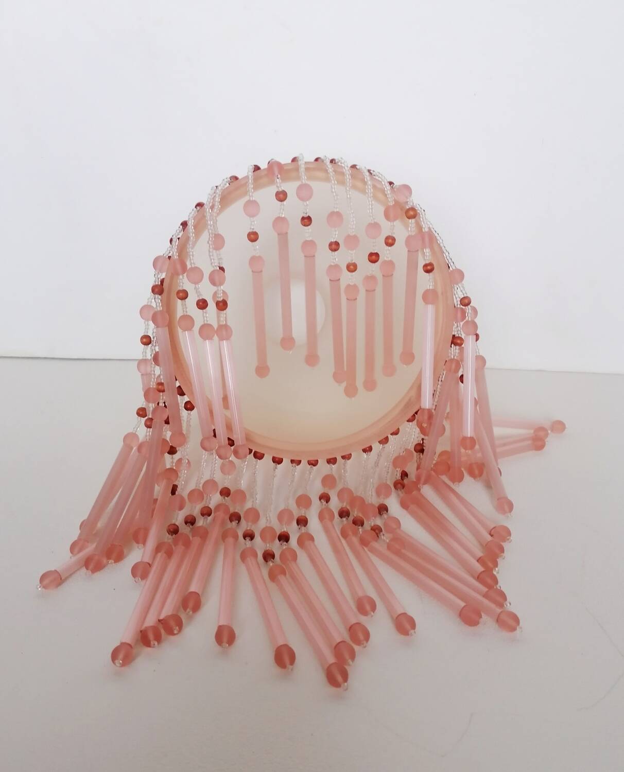 Pink glass wall lamp with garland of pearls