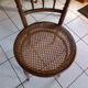 Curved wooden chair, turned and seated in cannage