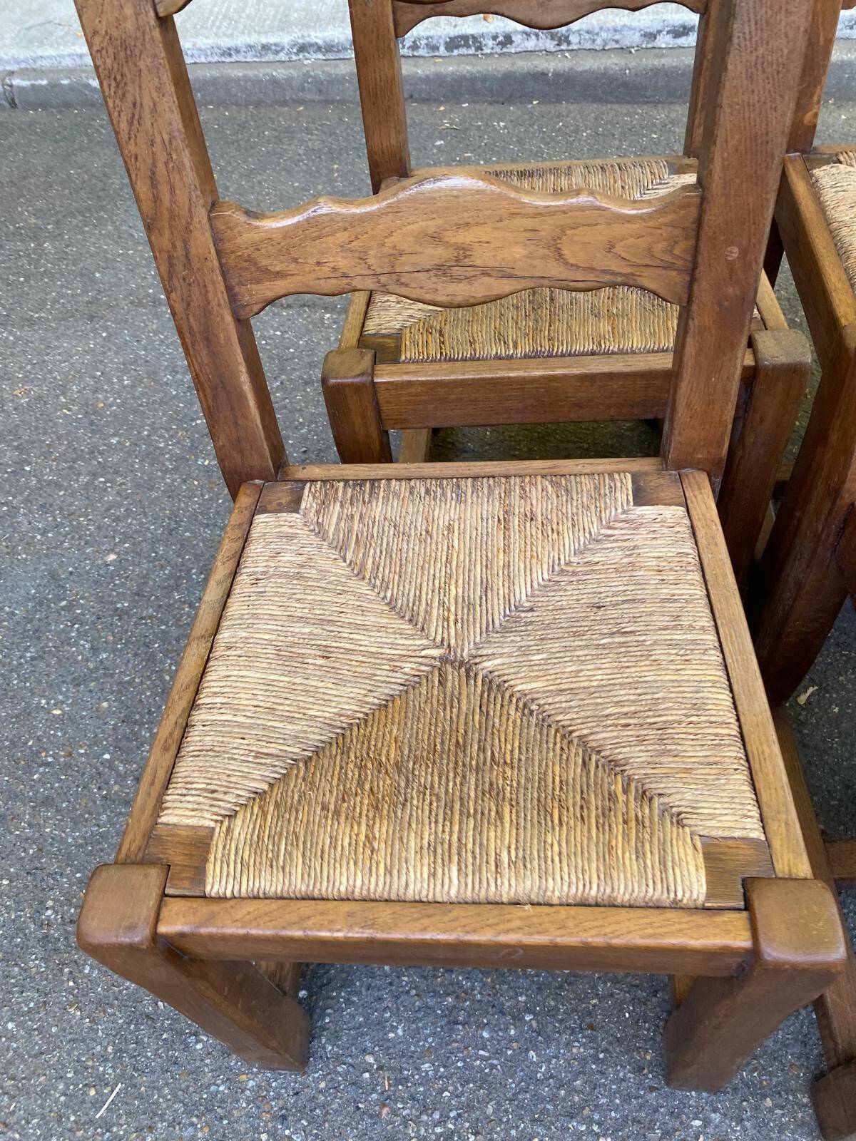 6 solid oak chairs with rush seats in a country style.
