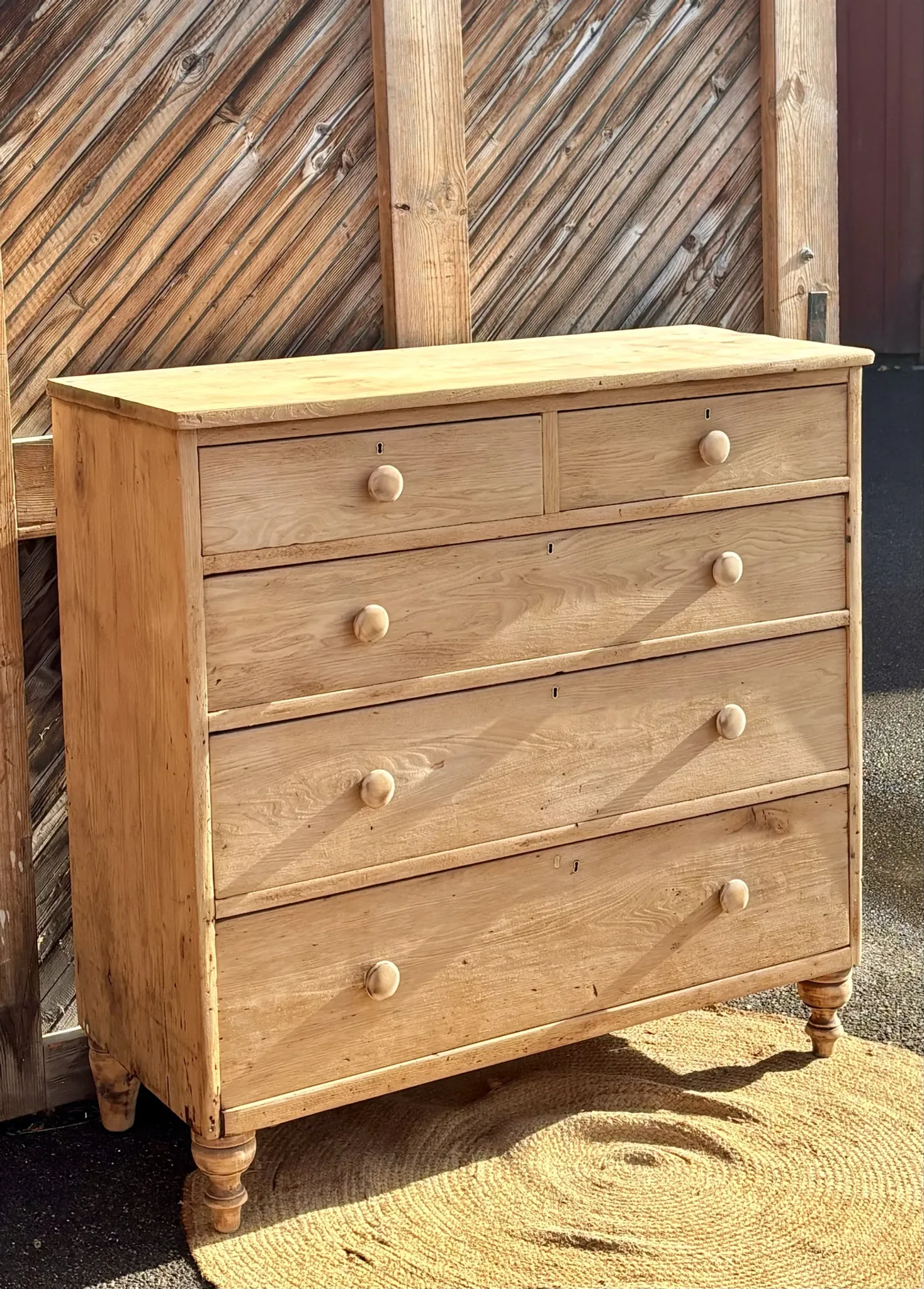 Large antique English chest of drawers in raw solid oak.