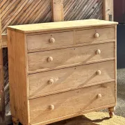 Large antique English chest of drawers in raw solid oak.