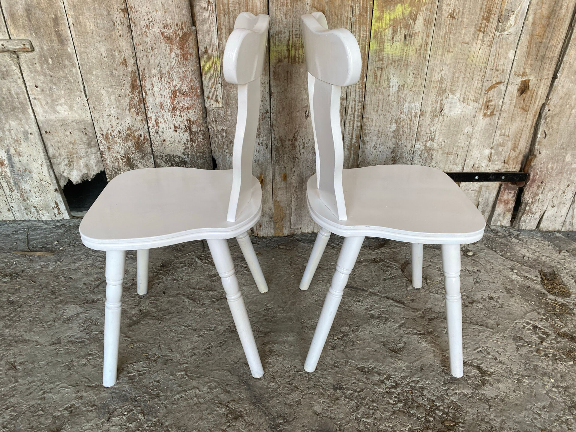 Pair of vintage white wooden bistro chairs