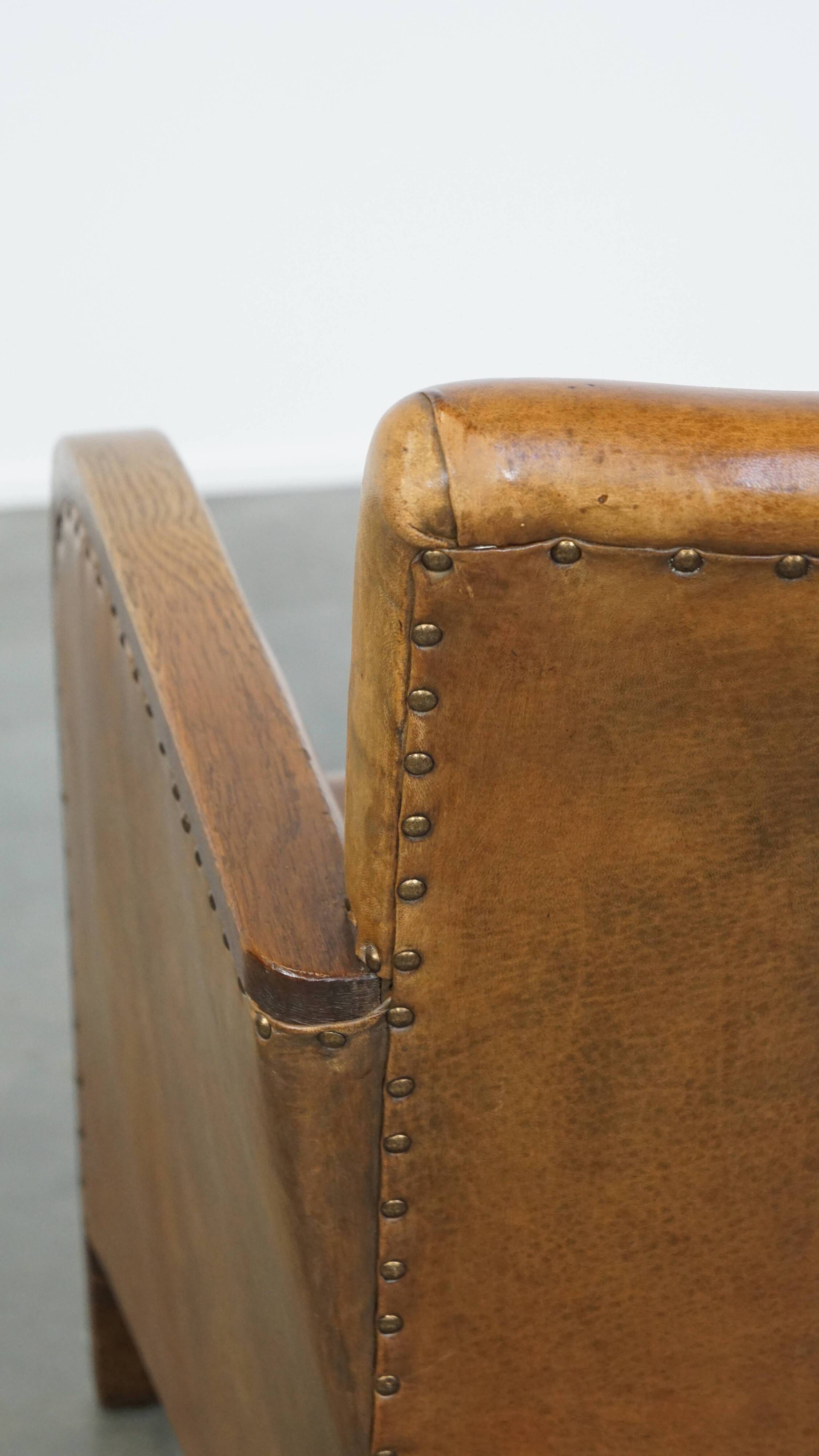Cognac-colored sheepskin and wooden Art Deco design armchair