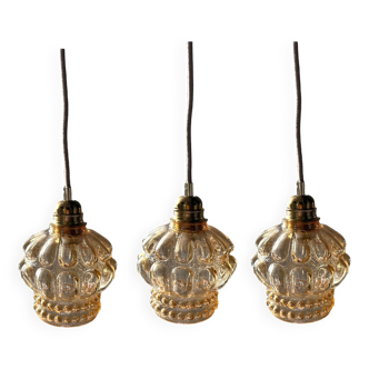 Set of three gold glass pendant lights
