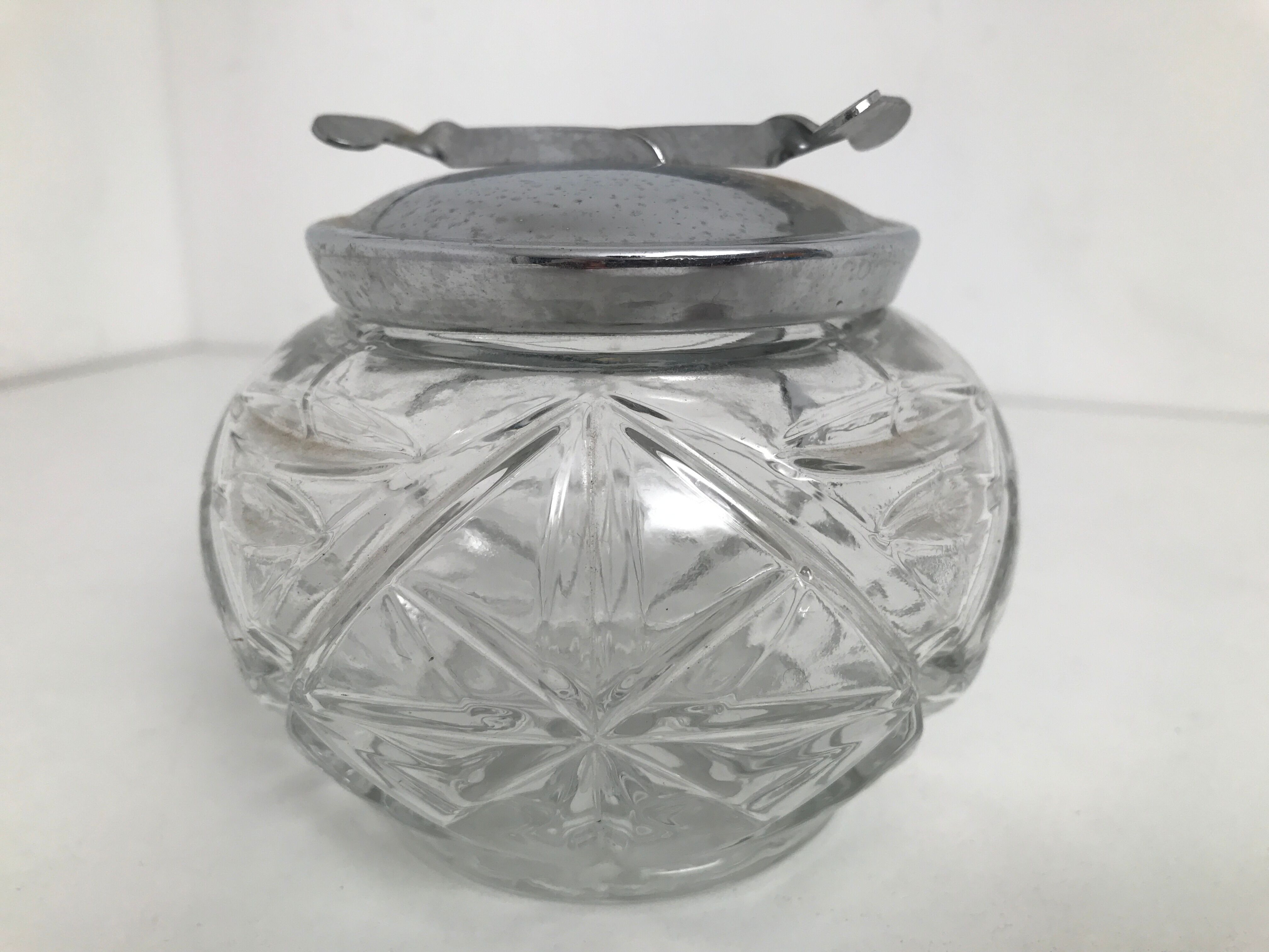 Structured glass sugar and chrome metal lid with built-in pliers