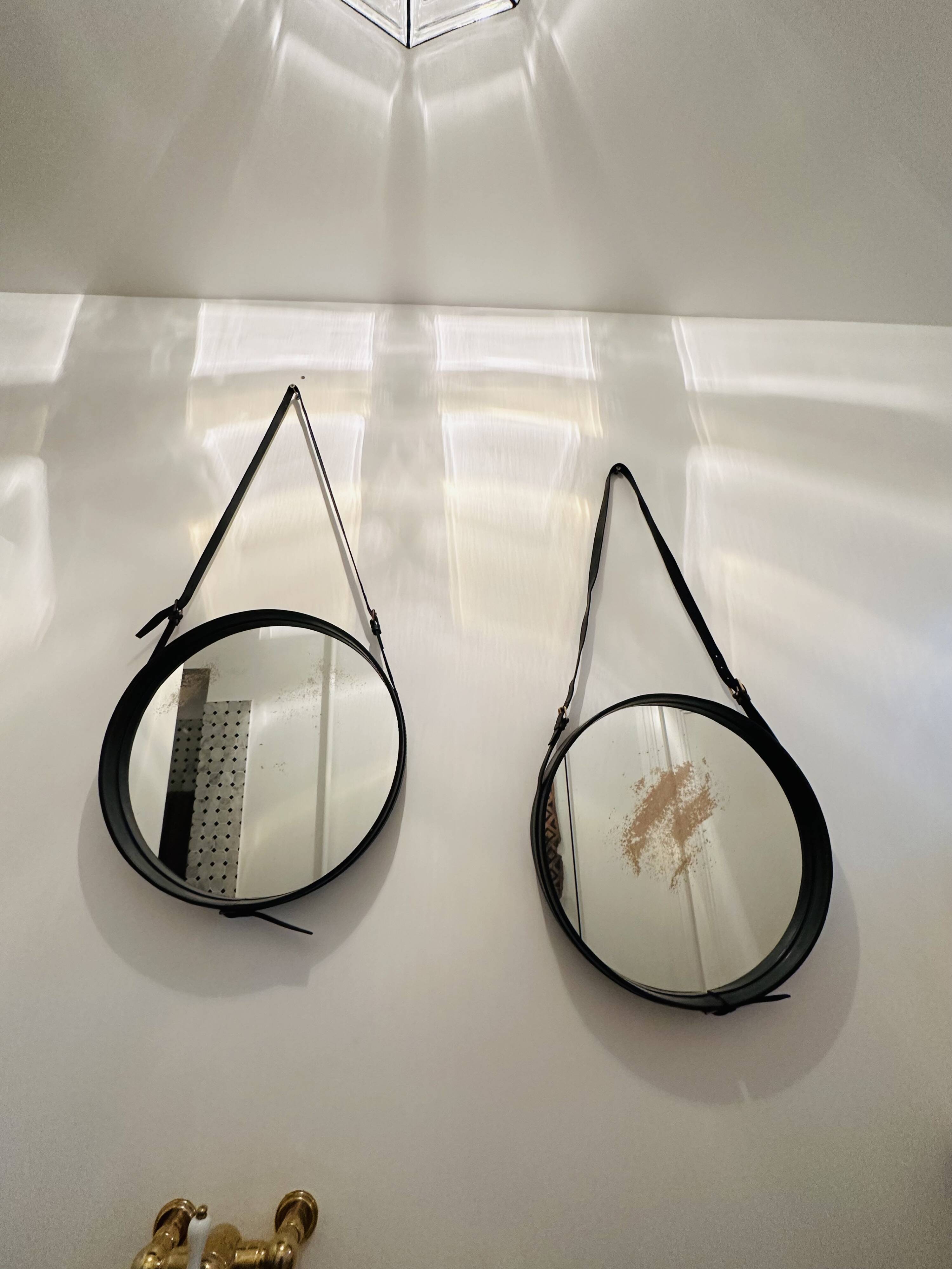 Jacques Adnet pair of circular leather and brass mirrors