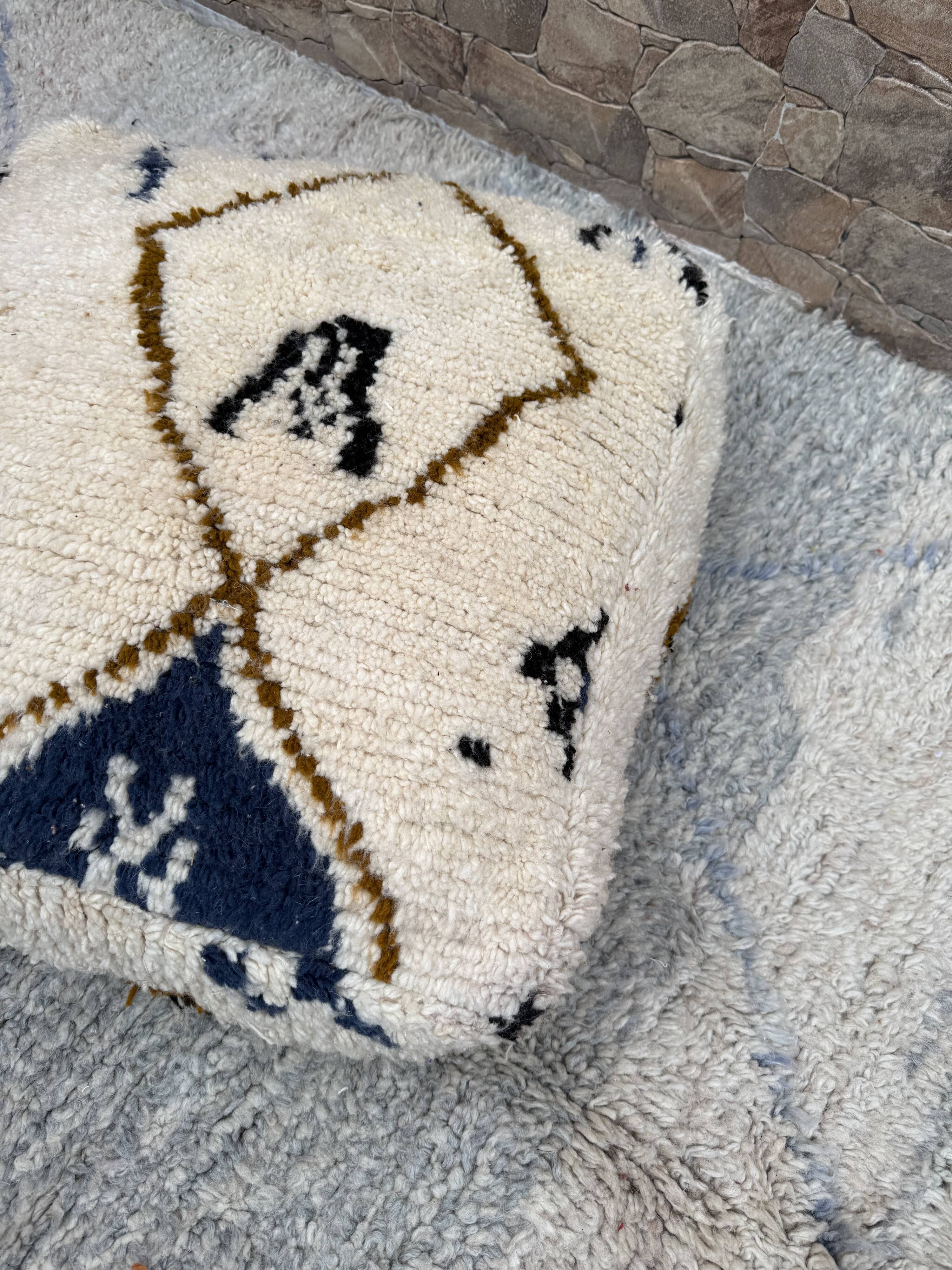 Berber floor pouf: Handwoven Moroccan wool cushion.