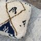 Berber floor pouf: Handwoven Moroccan wool cushion.