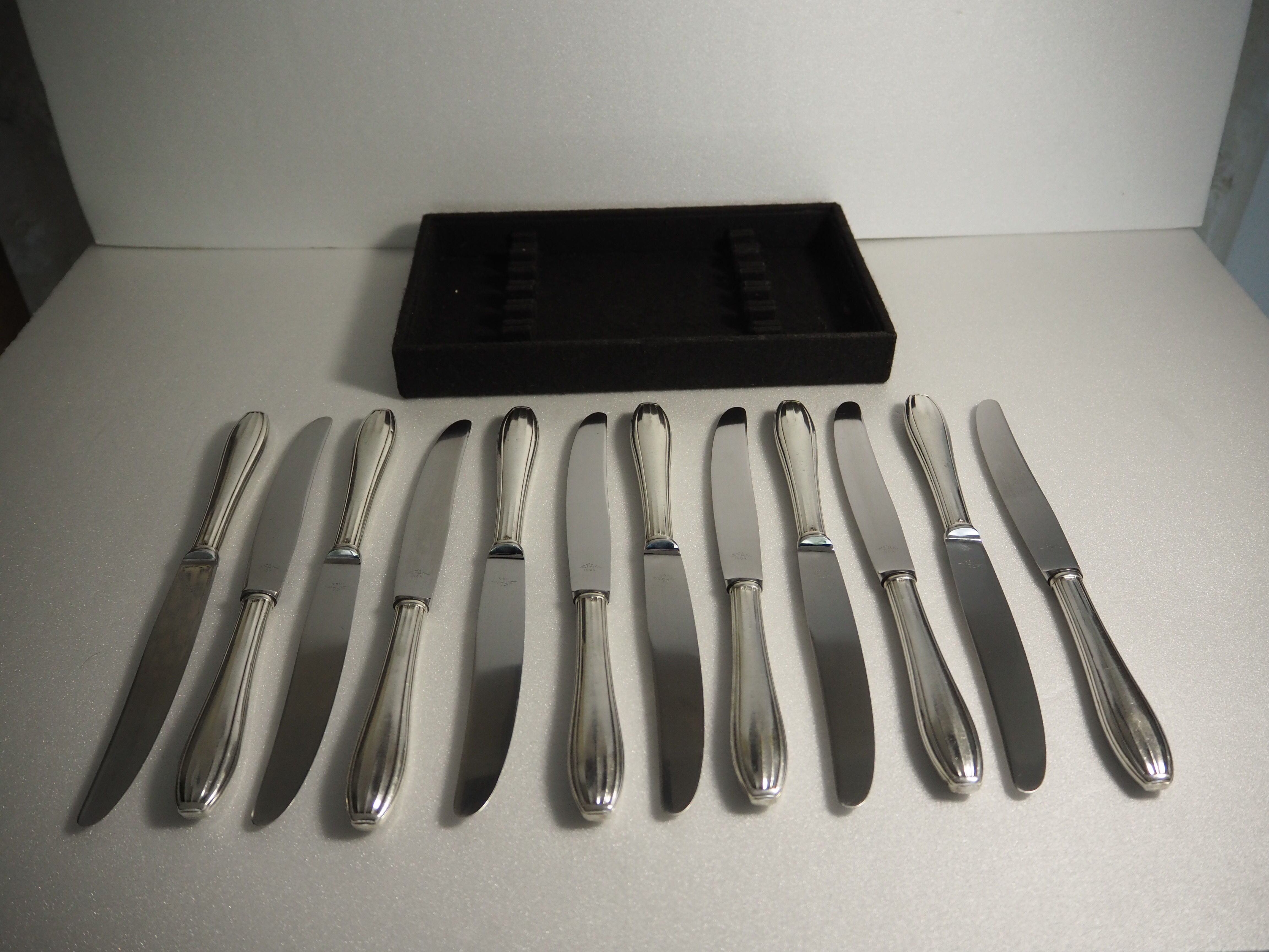 12 SFAM cheese knives in its dark chocolate case