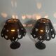Pair of black wrought iron lanterns with heart patterns, romantic style.