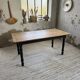 Oak farmhouse table with turned black legs.