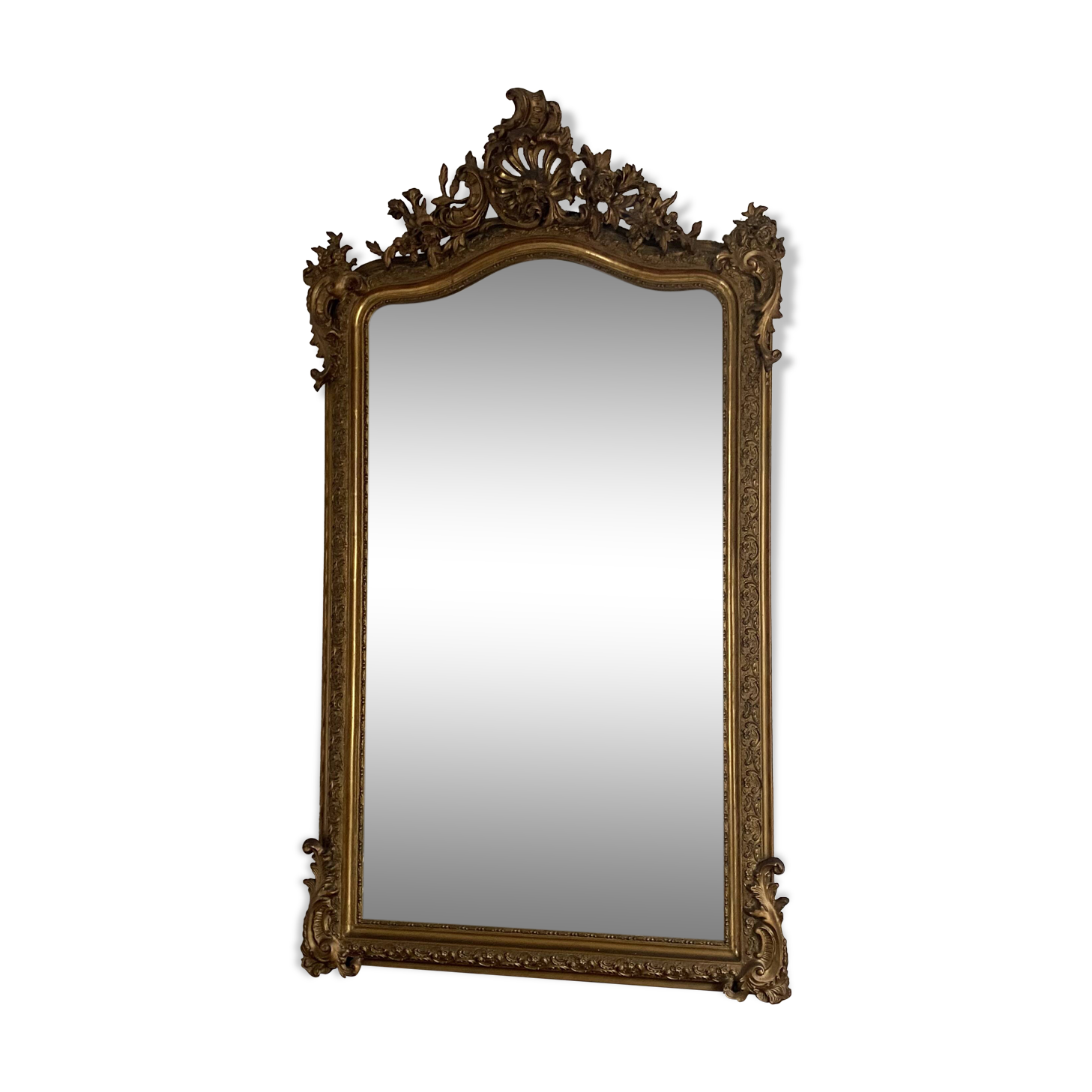 Late 19th century gilded mirror with decorated pediment. 155x88.