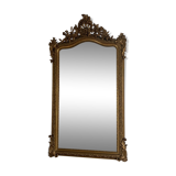 Late 19th century gilded mirror with decorated pediment. 155x88.