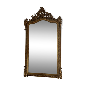 Late 19th century gilded mirror with decorated pediment. 155x88.