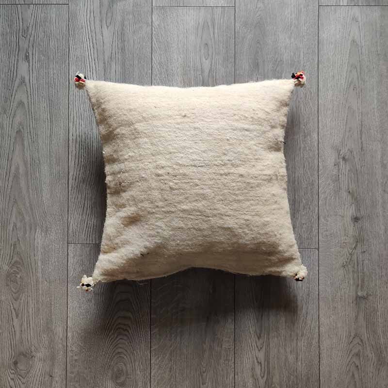 Off-white Berber cushion with wool pompom