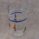 Vintage jug carafe for lemonade and juice, boats by the seaside, France.