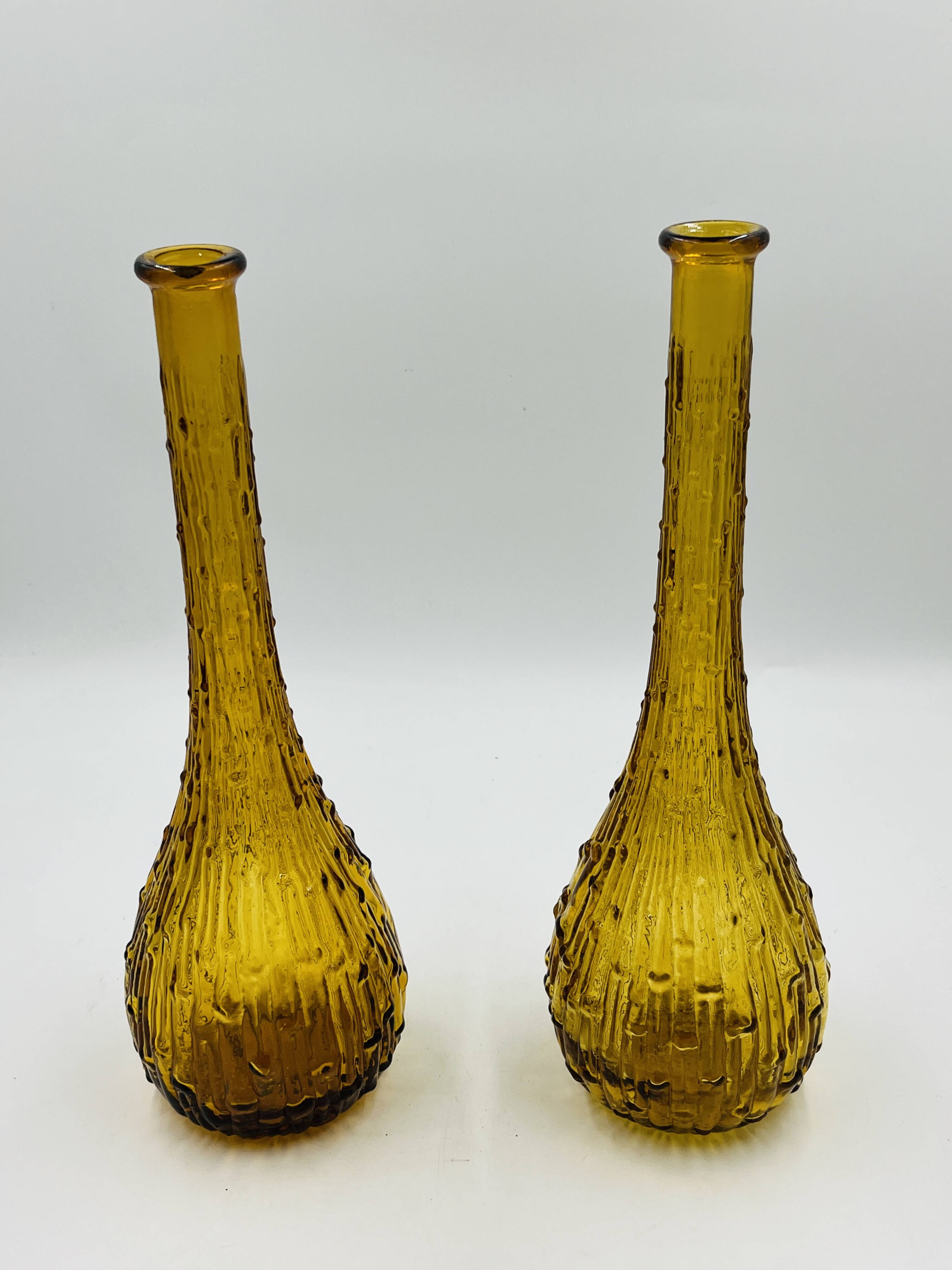 Set of two vintage textured amber glass Empoli bottles.