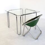 Italian vintage dining table with smooth glass and tubular frame base