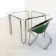Italian vintage dining table with smooth glass and tubular frame base
