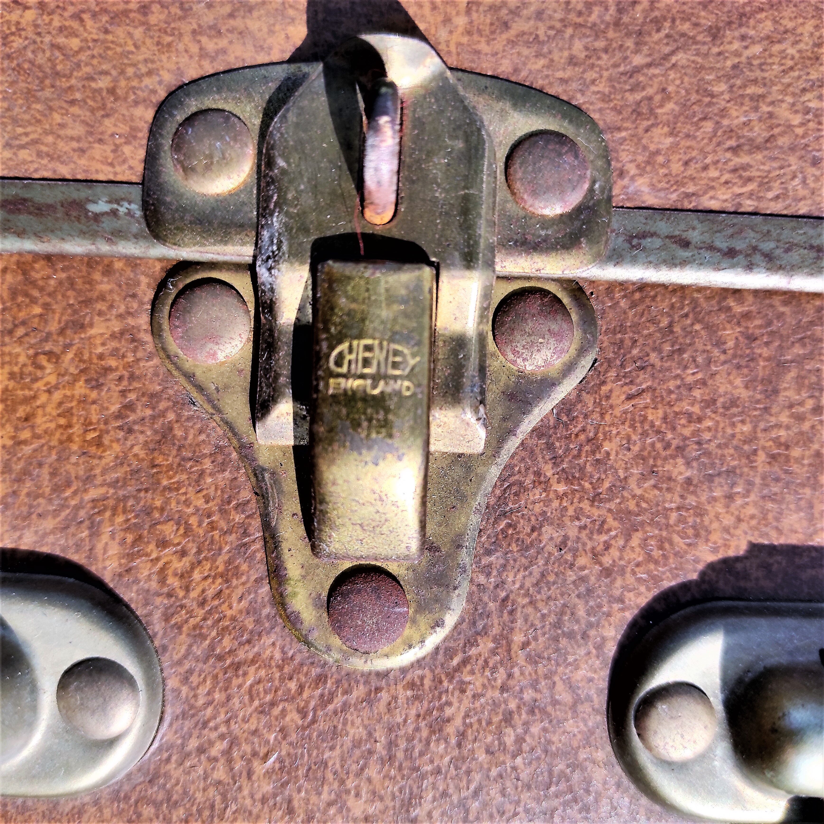 Brown vintage suitcase with CHENEY England brand travel tags