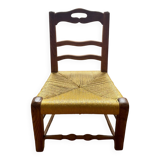 Low chair in wood and woven straw