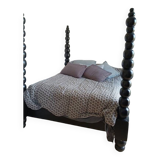 Black, solid wood four-poster bed, made by a craftsman in Mexico