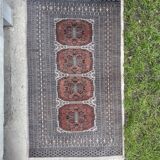 Vintage hand knotted rug with geometric patterns on a grey/beige/terracotta background 170 x 96 cm