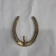 Horseshoe-shaped brass coat rack