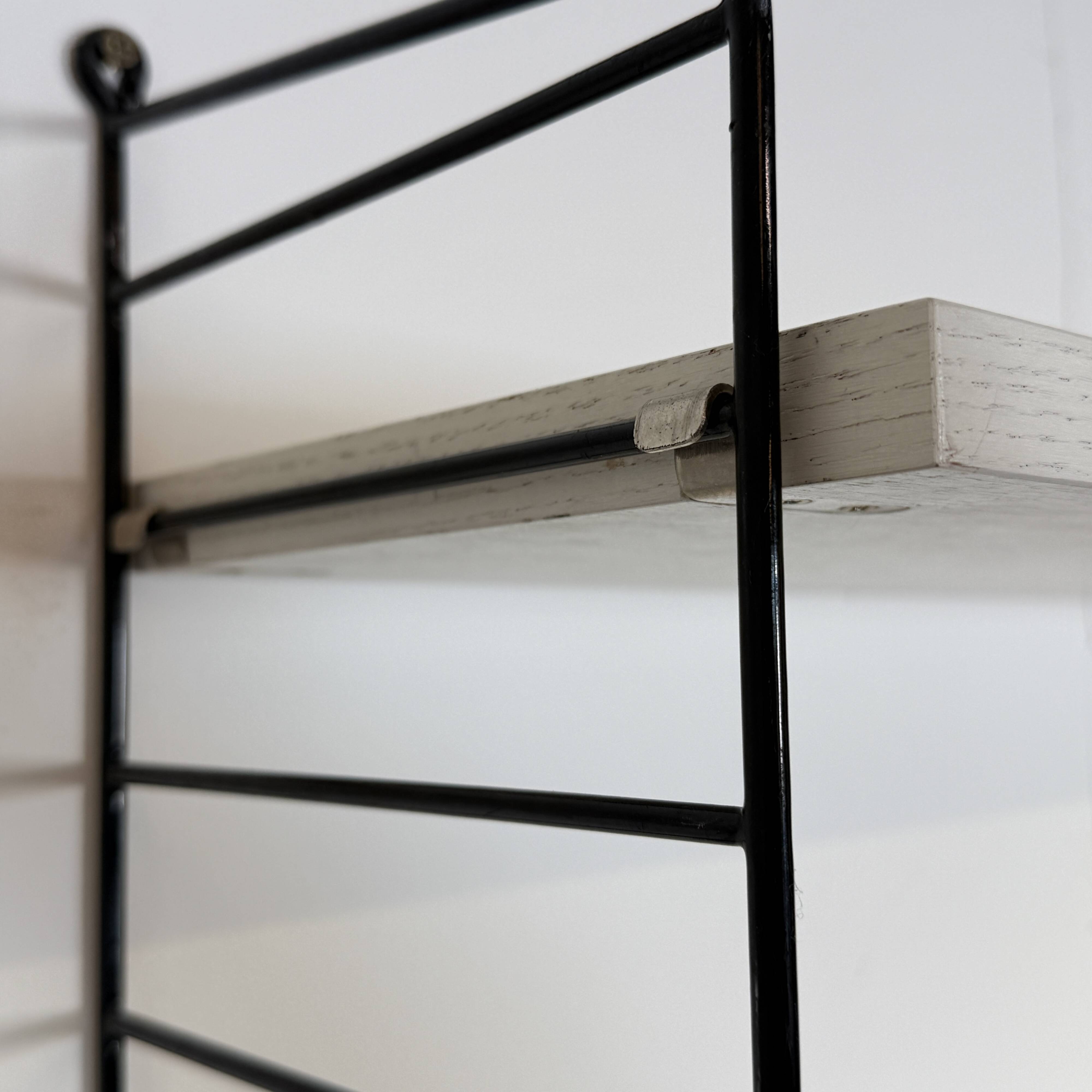 Vintage Nisse Strinning wall rack with 7 white shelves