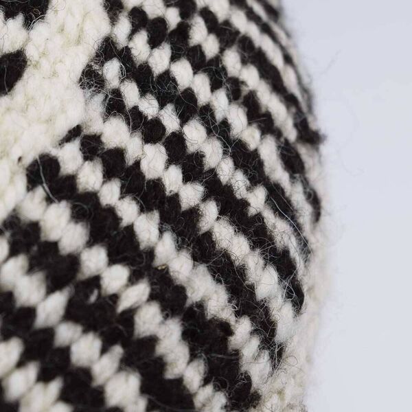 Coussin rond en laine à motifs blanc