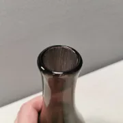 A unique vase in hand-blown glass with a hint of purple in the colour.