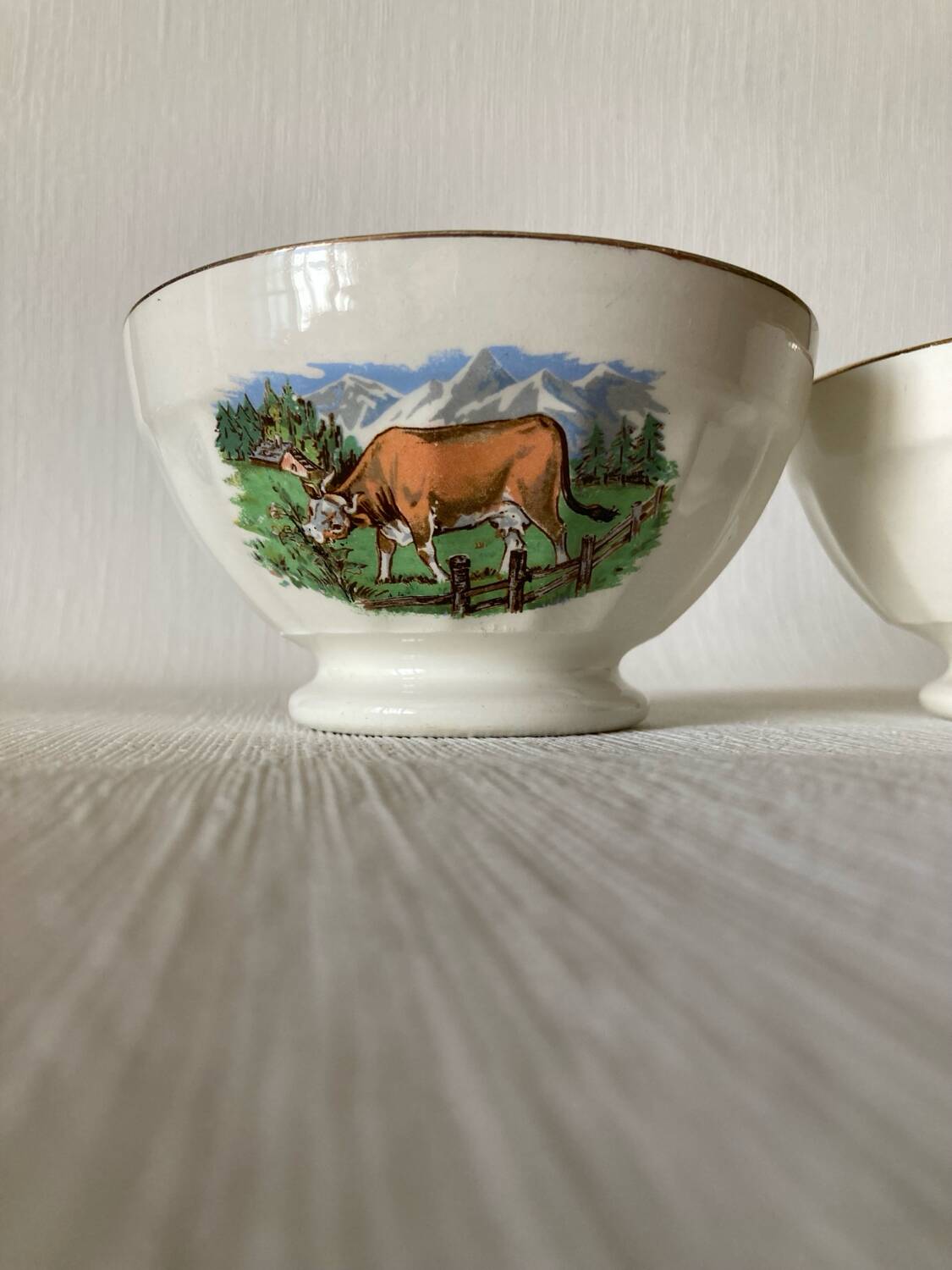 Pair of small faceted bowls with cow illustrations from the 40s and 50s