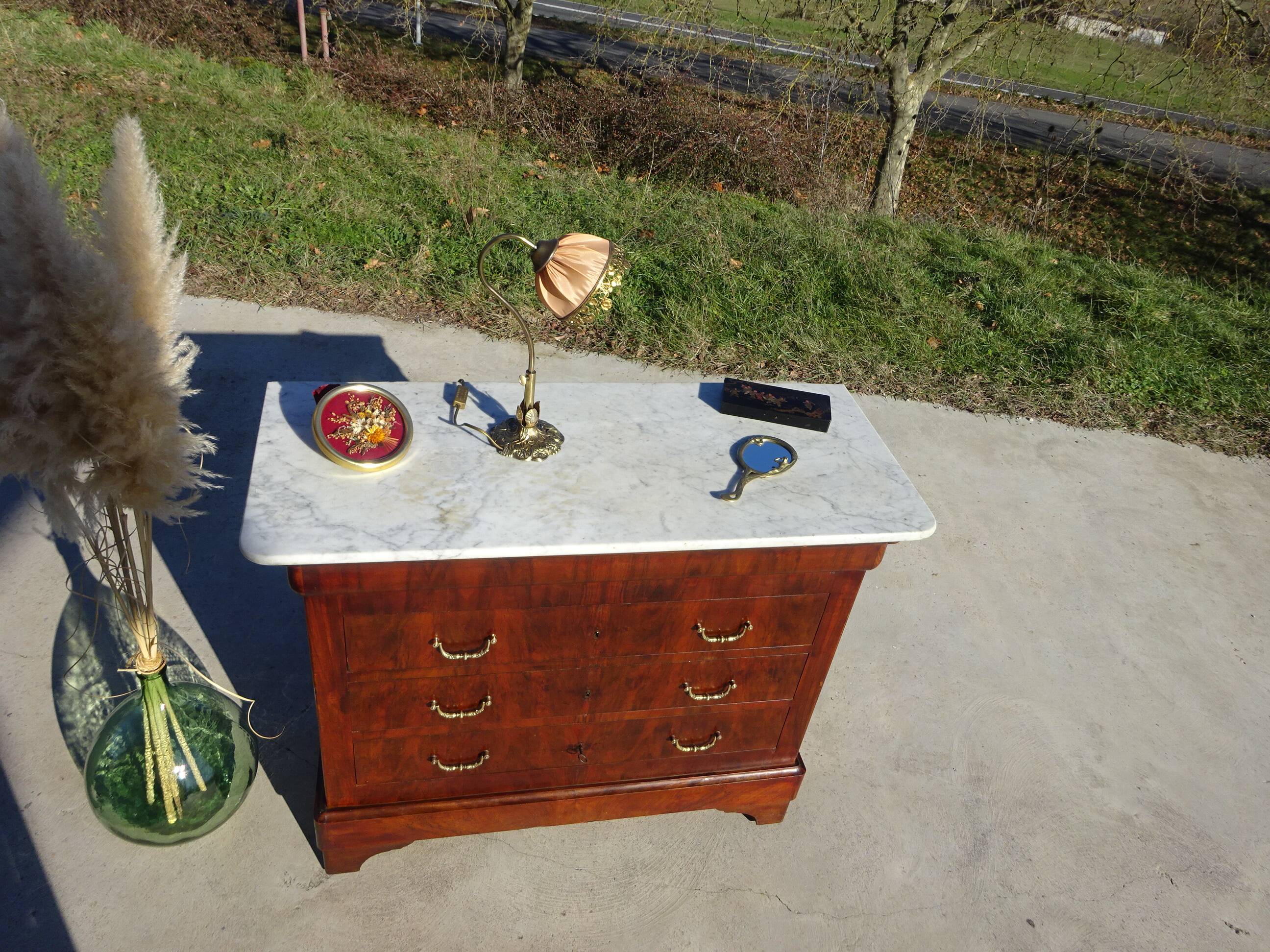 Antique mahogany chest of drawers with white marble.