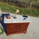 Antique mahogany chest of drawers with white marble.