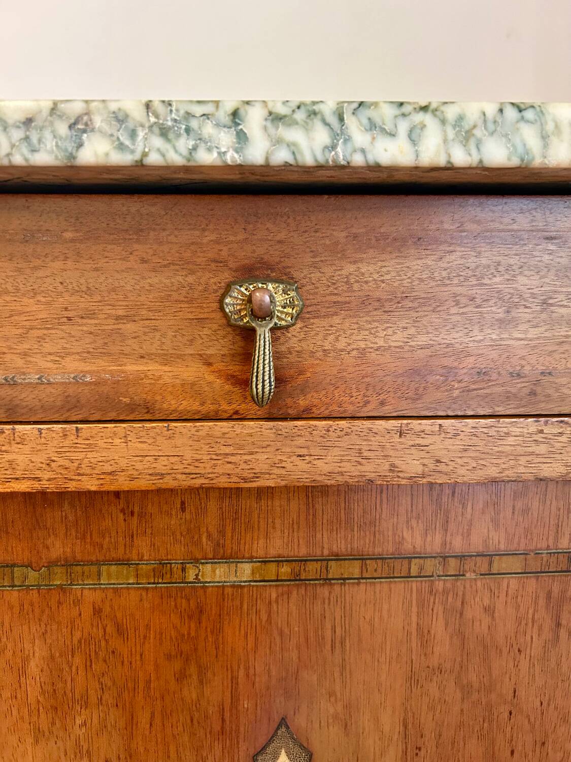 Antique bedside table in wood and marble – adorned with gilded brass ornaments –